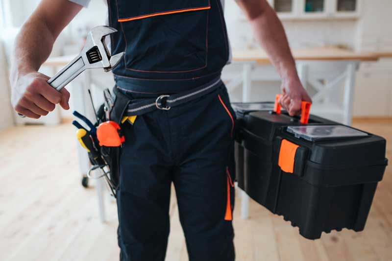 handyman-holding-toolbox-wrench-hands